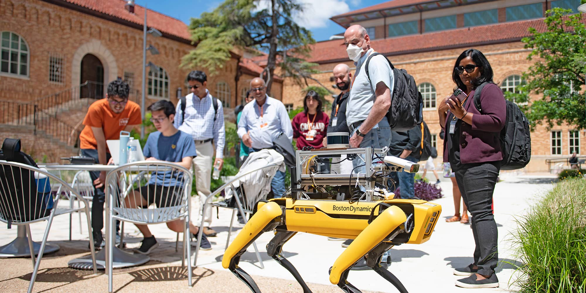 A group of people observing a robotics demonstration.