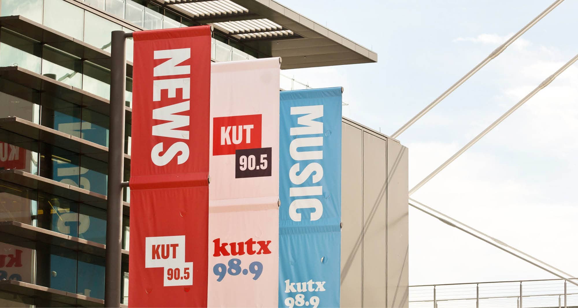 KUT 90.5 and kutx 98.9 banners on the side of a building