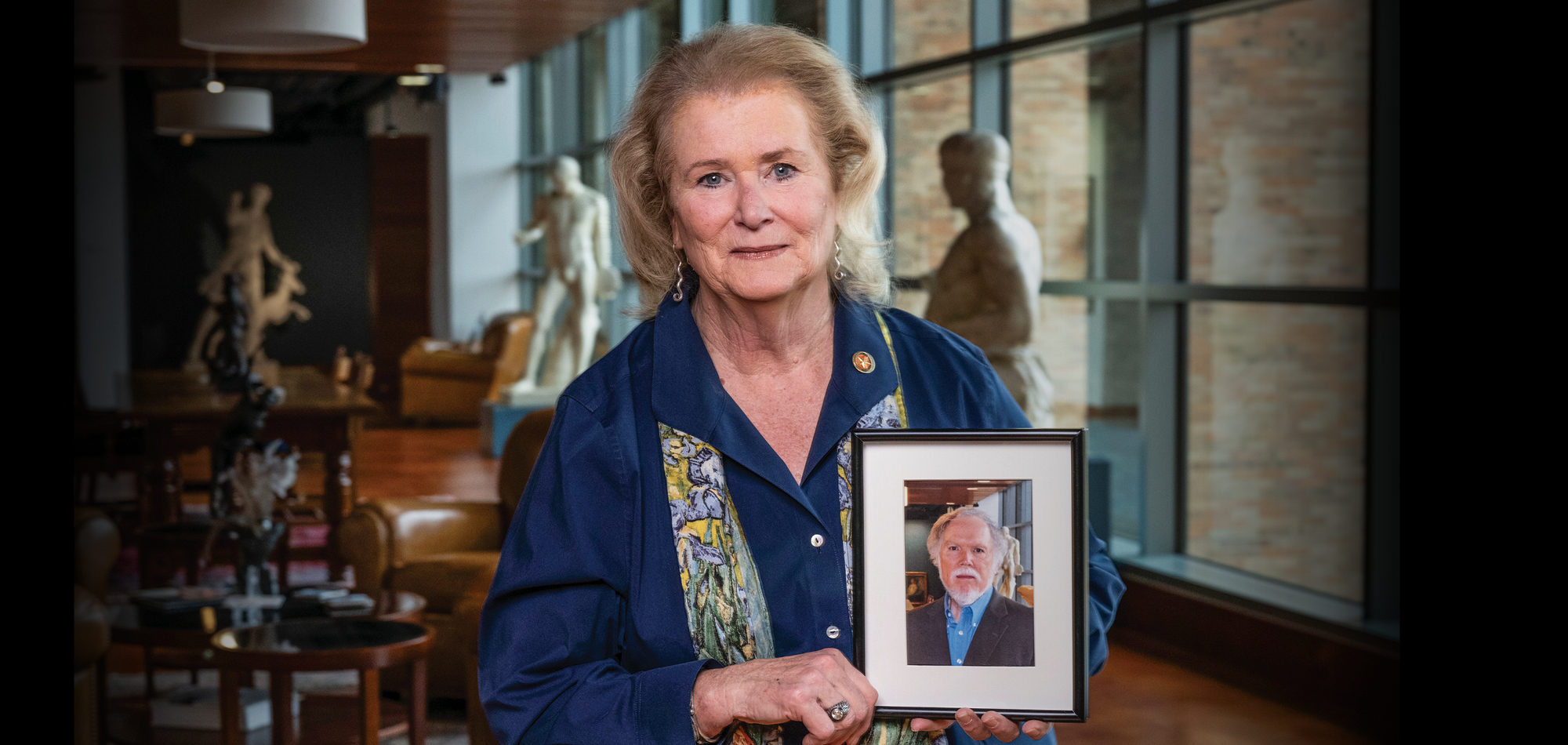 Jan Todd holding a photo of her husband Terry Todd