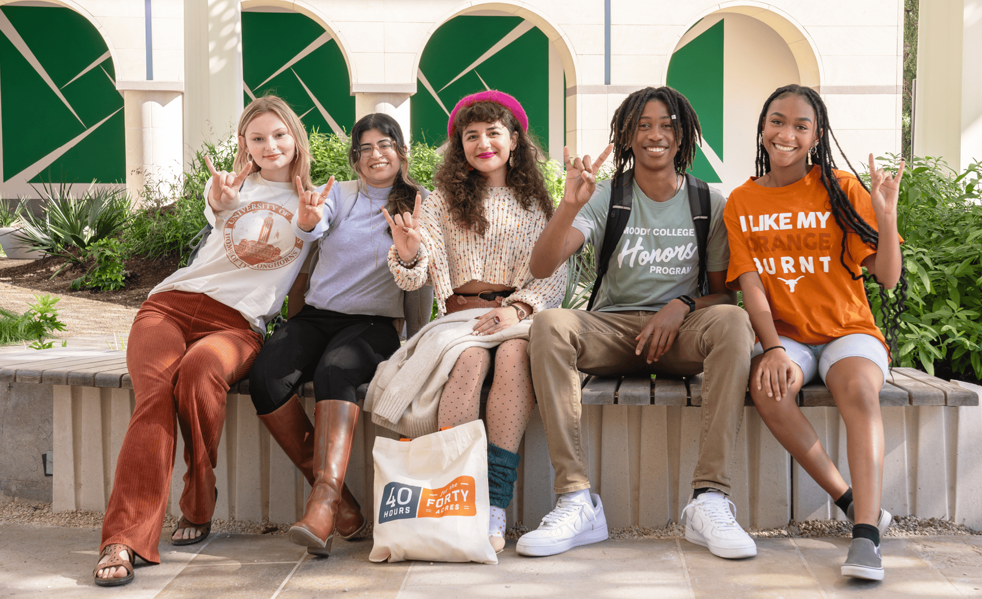 Five UT students sitting in a row.