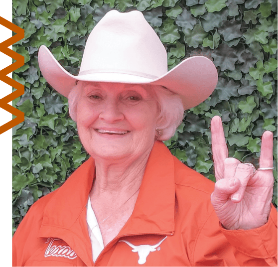 JoLyn Peters gesturing hook-em horns