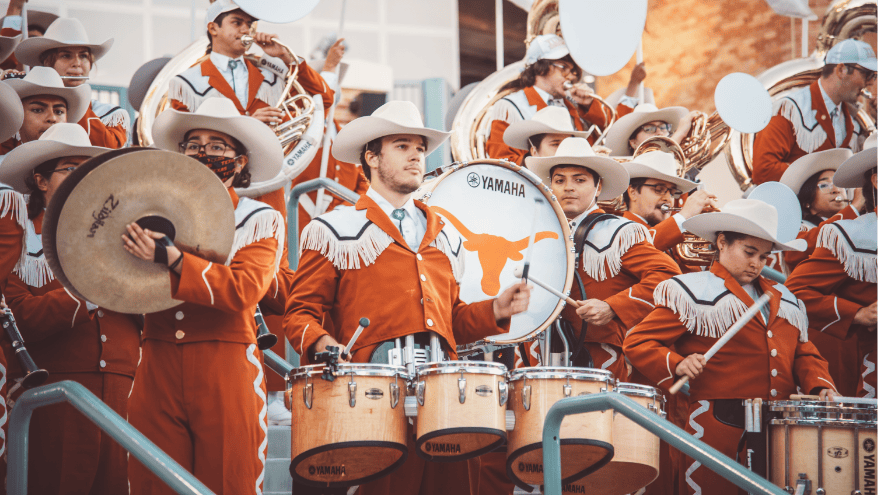 Longhorn Band members with drums and instruments