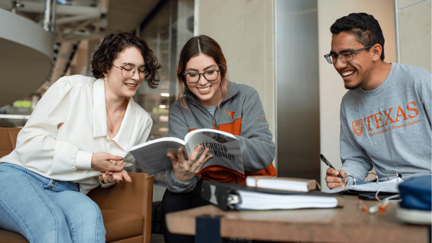 UT Students looking at a booklet