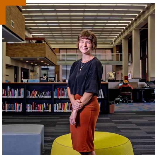 UT student standing in a library