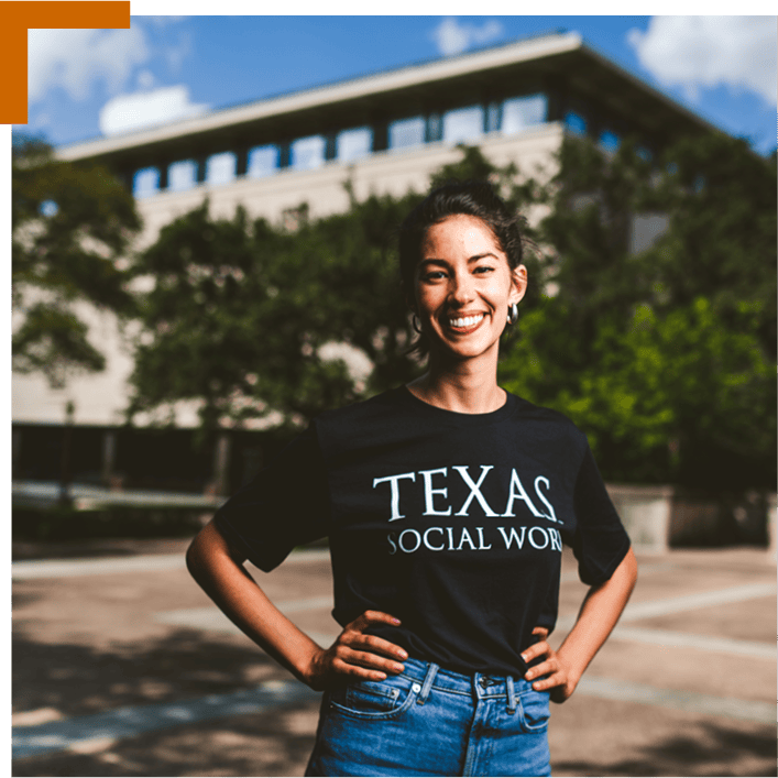 ENG SupportingPhoto A UT student with a shirt that says Texas Social Work, standing outside.
